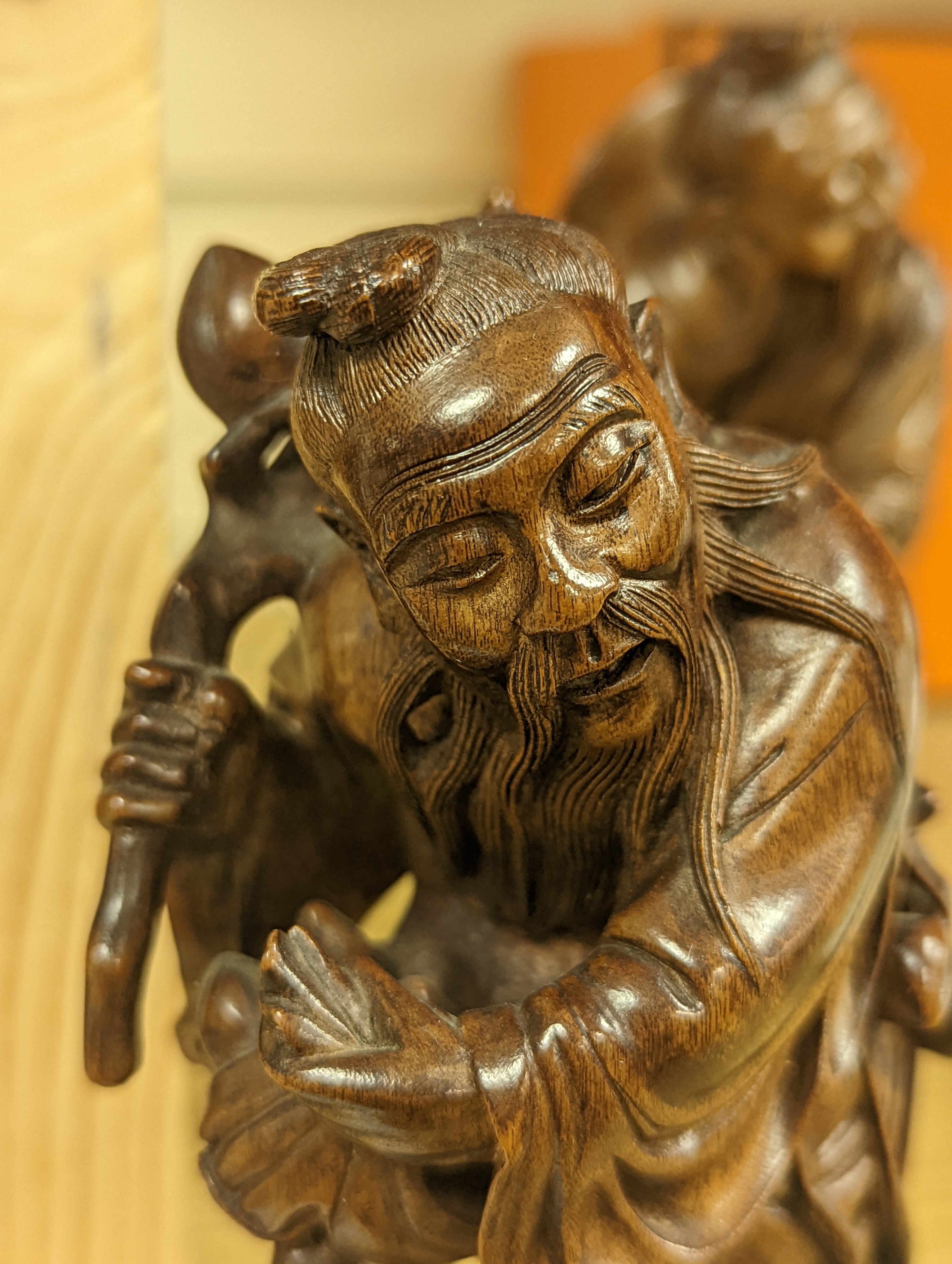 Two Chinese hardwood figures of a fisherman and a old man holding peaches 16cm